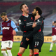 Livereepool’s Jordan Henderson hugs Mohamed Salah